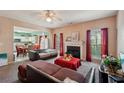 Inviting living room with a fireplace, large windows, and an open view to the kitchen and dining area at 415 Clairidge Sw Ln, Lawrenceville, GA 30046