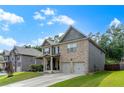 Beautiful home with well-maintained lawn, a two-car garage, and classic brick and siding exterior at 180 Cleburne, Acworth, GA 30101