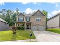 Inviting brick home with a green lawn, a charming covered porch, and a two-car garage at 180 Cleburne, Acworth, GA 30101