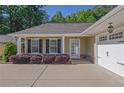 Inviting home exterior boasting manicured landscaping and a covered front entry at 308 Jessica Way, Canton, GA 30114