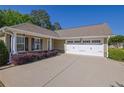 Charming home featuring a manicured lawn, attached garage, and a welcoming entrance at 308 Jessica Way, Canton, GA 30114