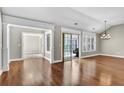 Elegant living room featuring hardwood floors, crown molding, and natural light from the sliding door at 308 Jessica Way, Canton, GA 30114