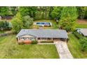 Aerial shot showcasing the charming brick home, the lush backyard, and a refreshing pool at 690 Manor Ridge Sw Dr, Mableton, GA 30126