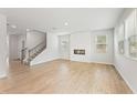 Bright and airy living room with fireplace, wood floors, and ample natural light at 7115 Brushwood Bend (Lot 46), Lithonia, GA 30058