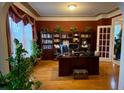 Home office featuring hardwood floors, and built-in bookshelves, creating a comfortable work environment at 104 Lumby Ln, Stockbridge, GA 30281