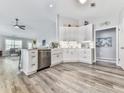 Open concept kitchen with stainless steel appliances and bright white cabinets at 305 Nobleman Way, Canton, GA 30114