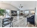 Bright living room featuring a fireplace, ceiling fan, and lots of natural light at 305 Nobleman Way, Canton, GA 30114