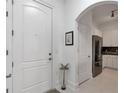 Bright entryway with a white door and an arched doorway to the kitchen at 3621 Vinings Slope Se # 3204, Atlanta, GA 30339