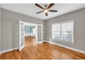 Bedroom featuring hardwood floors, a ceiling fan, and double doors leading to another room at 3634 Lost Oak Dr, Buford, GA 30519