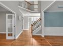 Grand foyer with gleaming hardwood floors, high ceilings, and staircase leading to the second floor at 3634 Lost Oak Dr, Buford, GA 30519