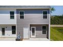 Rear exterior of modern townhome, showing neutral siding and private outdoor space at 4277 Arcadia Dr, Decatur, GA 30034