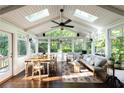 Cozy sunroom featuring skylights, ample seating, and natural light filtering through large windows at 540 Cambridge Way, Atlanta, GA 30328