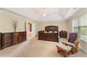 Large main bedroom with trey ceiling and a doorway to an ensuite bathroom at 150 Fitzroy Ln, Acworth, GA 30101