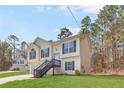 Attractive two-story home with neat landscaping, a two-car garage, and convenient side stairs to the entrance at 7806 Poppy Seed Pl, Winston, GA 30187