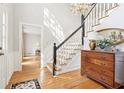 Bright foyer showcases hardwood floors and an elegant staircase with a chandelier at 918 Guinevere Way, Lilburn, GA 30047