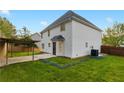 Large backyard featuring a covered patio area and green lawn at 1389 Shadow Creek Ave, Hampton, GA 30228