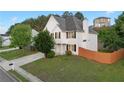 Well-maintained two-story home featuring a fenced yard and established landscaping at 1389 Shadow Creek Ave, Hampton, GA 30228