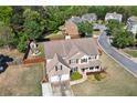 Two-story brick home with a large backyard, patio, fire pit, and shed at 209 Crestmont Way, Canton, GA 30114
