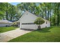 Side view of a well-maintained home, highlighting the attached two-car garage at 2139 Briar Glen Sw Ln, Atlanta, GA 30331