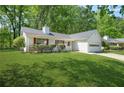 Quaint one-story home featuring a lush green lawn and an attached two-car garage at 2139 Briar Glen Sw Ln, Atlanta, GA 30331