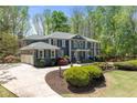 Elegant two-story home with a wide driveway, lush landscaping, and well-maintained lawn at 335 Birkdale Dr, Fayetteville, GA 30215