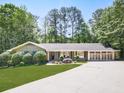 Charming single-story home with lush front lawn, mature landscaping, and a three-car garage, offering great curb appeal at 4307 Smithsonia Ct, Tucker, GA 30084