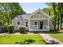 Inviting exterior featuring a well-manicured lawn and a cozy front porch perfect for enjoying the outdoors at 1084 Regent Sw St, Atlanta, GA 30310