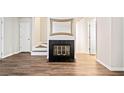 Living room showing a fireplace, neutral walls and hardwood-style floors at 200 High Creek Dr, Roswell, GA 30076