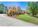 Stately brick home with meticulously maintained grounds, showcasing an inviting exterior and curb appeal at 562 Grassmeade Way, Snellville, GA 30078