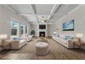 Bright living room with coffered ceilings, fireplace, and large windows providing natural light at 1543 Dover Creek Ln, Lawrenceville, GA 30045