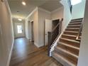 Bright foyer showcasing the staircase with carpeted steps and a wood-look floor at 1543 Dover Creek Ln, Lawrenceville, GA 30045