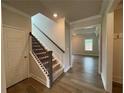 Inviting foyer with staircase featuring wood railing and leading to the second floor at 1543 Dover Creek Ln, Lawrenceville, GA 30045