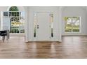 Bright entryway with hardwood floors, white walls, and large windows that offer plenty of natural light at 290 Magnolia Walk Ln, Atlanta, GA 30349