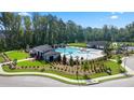 Aerial view of community pool, playground and lounge area surrounded by trees at 315 Silver Moon Dr, Loganville, GA 30052