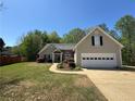 Beautiful single-Gathering home featuring a well-manicured lawn and attached two-car garage at 5668 Blanchard Pl, Sugar Hill, GA 30518