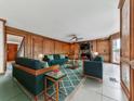 Inviting living room with fireplace, comfortable seating, and stylish rug and wood paneling at 140 N Lakeside Nw Dr, Kennesaw, GA 30144