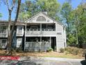Charming two-story townhome featuring a covered front porch, second story balcony, and beautifully landscaped surroundings at 1490 N Crossing Circle Ne Cir # 1490, Atlanta, GA 30329