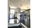 View of kitchen with stainless steel appliances, white cabinets, and hardwood floors at 6125 Connell Rd, Atlanta, GA 30349