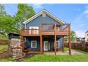 The back exterior has a wooden deck and a stone fireplace at 650 Ira Sw St, Atlanta, GA 30312