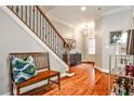 Welcoming foyer with hardwood floors, a staircase with iron railings, and a decorative bench at 2250 W Village Junction Se Way, Smyrna, GA 30080