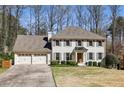 Beautiful two-story home with a two-car garage, landscaped yard, and classic facade with gray shutters at 4765 Karls Gate Dr, Marietta, GA 30068