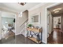 Inviting foyer with polished floors, decorative console table, and staircase leading to the upper level at 4765 Karls Gate Dr, Marietta, GA 30068