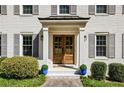 Elegant double front doors with decorative columns, sidelights, and well-maintained landscaping at 4765 Karls Gate Dr, Marietta, GA 30068
