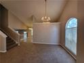 Dining room with vaulted ceilings, a chandelier, and access to the living room at 5820 Wellborn Oaks Ct, Lithonia, GA 30058