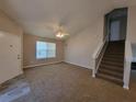 Inviting living room with new carpet, and a staircase leading to the upper level at 5820 Wellborn Oaks Ct, Lithonia, GA 30058