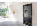 Close up view of a front door with secure black metal frame in a covered entryway at 725 Dalrymple Rd # 3G, Atlanta, GA 30328
