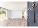 Bright and airy living room showcasing freshly painted walls, new flooring, and sliding door to outdoor patio at 725 Dalrymple Rd # 3G, Atlanta, GA 30328