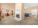 Inviting living room featuring a fireplace, neutral carpet, and views into other rooms at 8495 Spivey Village Way, Jonesboro, GA 30236