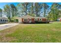 A cozy ranch-style home with a convenient carport and spacious front lawn at 3393 Ridgecrest Dr, Powder Springs, GA 30127