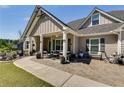 Inviting front porch with seating, potted plants, and stone-paved walkway at 7001 Palomino Trl, Winston, GA 30187